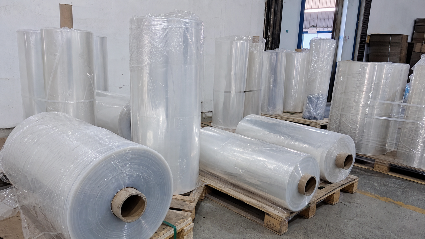 Clear plastic sheet rolls packed on pallets for bulk packaging material orders